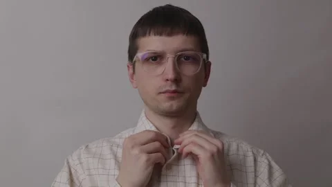 Young professional buttoning shirt while preparing for online job interview Stock Footage 335143519
