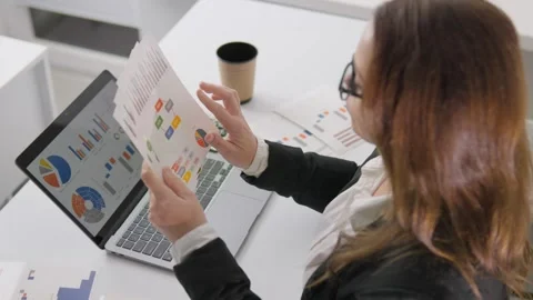 The young professional is engaged in business analytics and plans the strategic Stock Footage 260318529