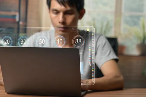 Young Professional Engaged with Digital Chart on Laptop Screen Stock Photos