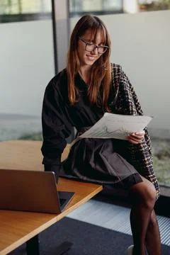 A Young Professional Engaged in a Project Within a Modern and Stylish Workspace Stock Photos