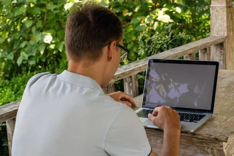 A Young Professional Engaged in Remote Work Outdoor Stock Photos