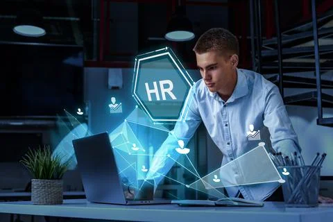 Young professional engaging with human resources technology in a modern office Stock Photos