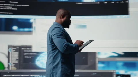 Young professional engineer focused on coding with tablet at an innovation hub Stock Footage 312304741