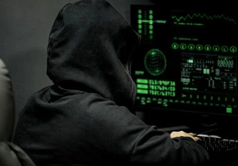 Young professional female hacker using keyboard typing bad data into computer Foto stock