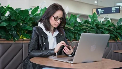 Young professional female manager using laptop in mall, businesswoman working Stock Footage 189483736