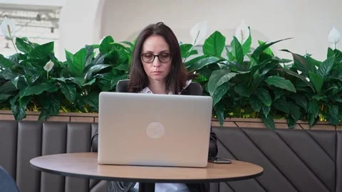 Young professional female manager using laptop in mall, businesswoman working Stock Footage 192259740