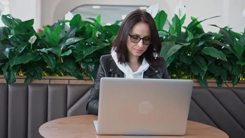 Young professional female manager using laptop in mall, businesswoman working Stock Footage 192837990