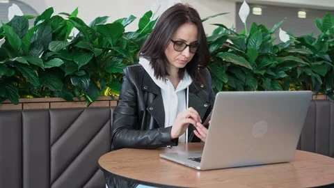 Young professional female manager using laptop in mall, businesswoman working Stock Footage 192839294