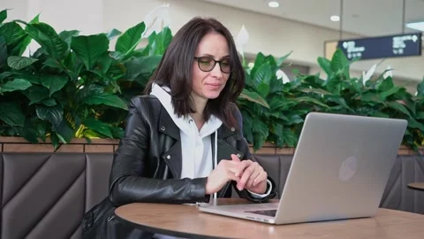 Young professional female manager using laptop in mall, businesswoman working Stock Footage 193529622