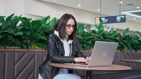 Young professional female manager using laptop in mall, businesswoman working Stock Footage 193529753