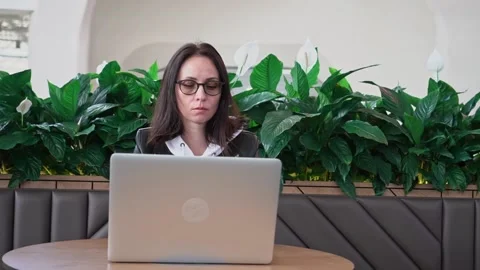 Young professional female manager using laptop in mall, businesswoman working Stock Footage 194505462