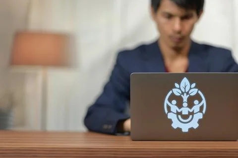 Young Professional Man Using Laptop with Growth and Innovation Logo in Offi.. Stock Photos