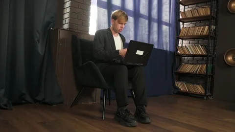 Young Professional Man Working on Laptop in Modern Study Room Stock Footage 343378641