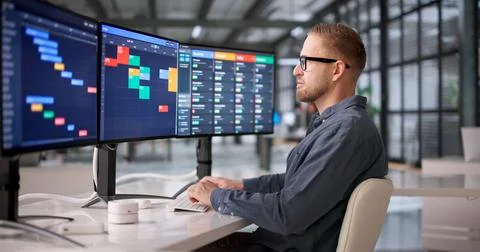 Young Professional Managing Project Schedule On Office Computer With Gantt Ch Stock Photos
