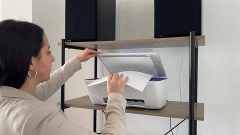 Young professional placing document in the scanner Stock Footage 331808996