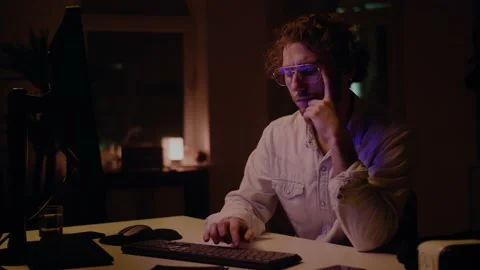 Young Professional Programmer Looking for Solution at Code. Late Night Work. Stockbeeldmateriaal 131266953