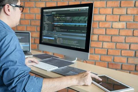 Young Professional programmer working at developing programming and website w Stock-Fotos