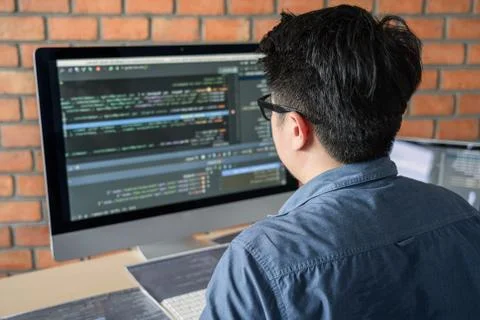 Young Professional programmer working at developing programming and website w Stock-Fotos