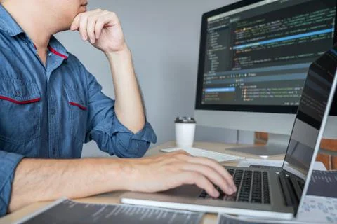 Young Professional programmer working at developing programming and website w Stock-Fotos