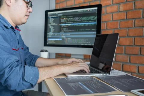 Young Professional programmer working at developing programming and website w Stock-Fotos