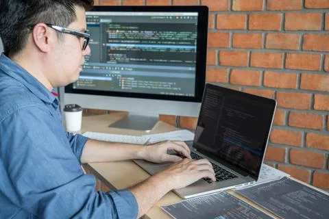 Young Professional programmer working at developing programming and website w Stock-Fotos