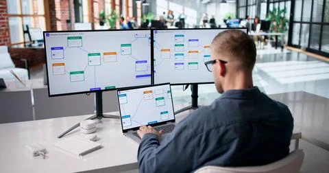Young Professional Streamlining Business Processes With Laptop Automation Too Stockfoto's