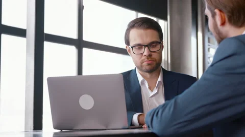 Young professional in a suit interviewing a man at the desk Stock Footage 179013219