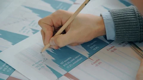 Young professional is writes on documents at desk in modern office. Stock Footage 89961018