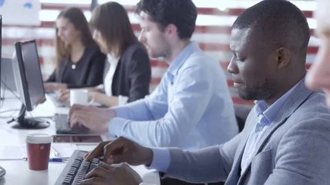 Young professionals sitting and working on the computers Stock Footage 73877894