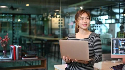 Young professionals web developer coder using laptop computer while standing in Stockfoto's