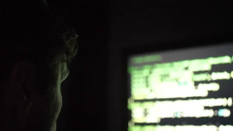 Young programist working on code late at night. Screen reflects green on his Stock Footage 128442391