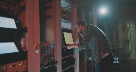 Young programmer coding in server typing on laptop Stock Footage 107339587