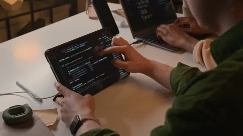 Young Programmer Coding on Tablet at White Office Desk 動画素材 336708076
