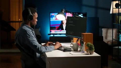 Young programmer engineer writing binary code data on terminal window 库存照片
