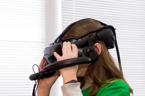 Young programmer girl in a virtual reality helmet. Stock-Fotos