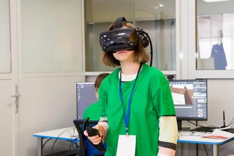 Young programmer girl in a virtual reality helmet. Stock-Fotos