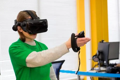 Young programmer girl in a virtual reality helmet. Foto stock