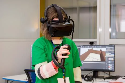 Young programmer girl in a virtual reality helmet. Stock-Fotos