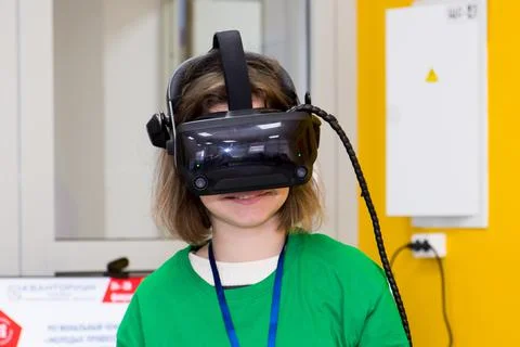 Young programmer girl in a virtual reality helmet. Stock-Fotos
