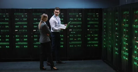 Young programmer holding laptop in his hands shows blonde woman manager the Video stock 152056326