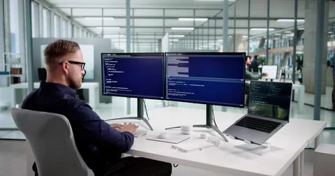 Young Programmer Man Coding Software On Desktop Computer At Office. Stock Photos