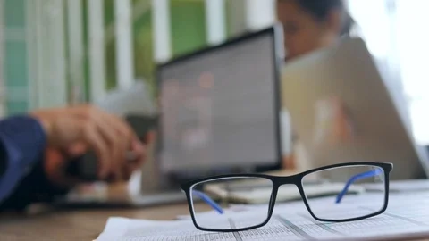 Young Programmer Man Puts On Glasses and Start Working on Computer Laptop Video stock 82105540