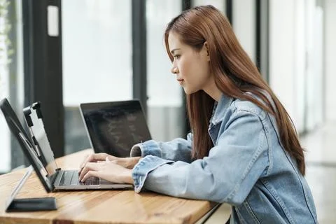 Young programmer or IT specialist satisfied with her work done.. Stock Photos