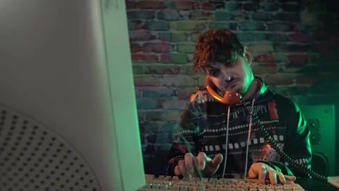 Young Programmer or IT Support Technician From 1980's Talking on Telephone in Stock Footage 298110367