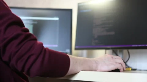 Young programmer to scroll programming code. Computer mouse in hand closeup Stock Footage 63421333