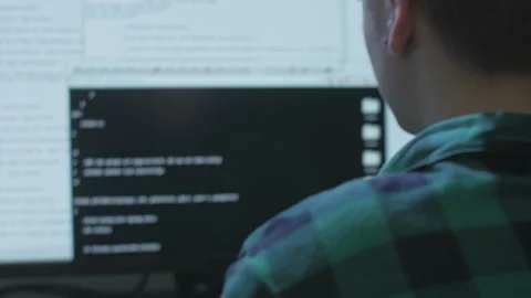Young programmer searching for bugs and fixing them in a client's code Stock Footage 142936475
