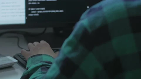 Young programmer searching for bugs and fixing them in a client's code Stock Footage 142941644