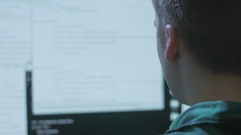 Young programmer searching for bugs and fixing them in a client's code Stock Footage 142947307