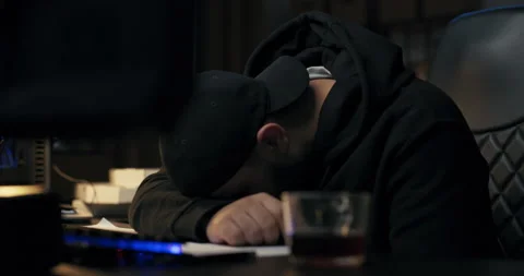 Young programmer sleeps on desk in front of computer at night, man fell asleep Stock Footage 177846608