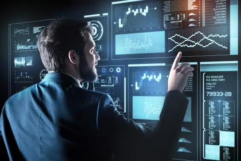 Young programmer smiling and feeling impressed by the new technologies Stock-Fotos